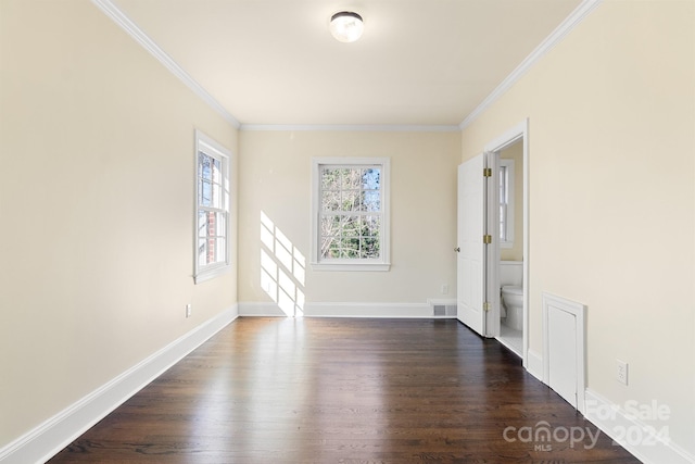 spare room with crown molding and dark wood-type flooring