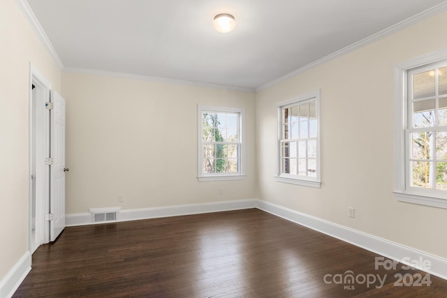 unfurnished room with plenty of natural light, dark wood-type flooring, and ornamental molding