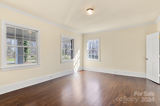 empty room with dark wood-type flooring and ornamental molding