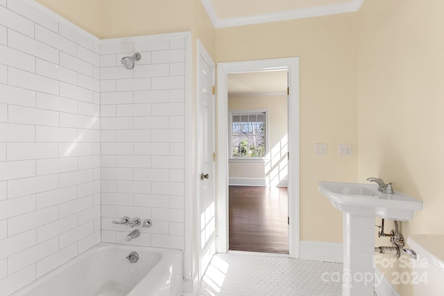 bathroom with crown molding, tiled shower / bath, and tile floors