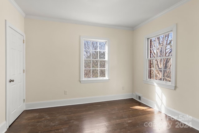 spare room with a wealth of natural light and hardwood / wood-style floors