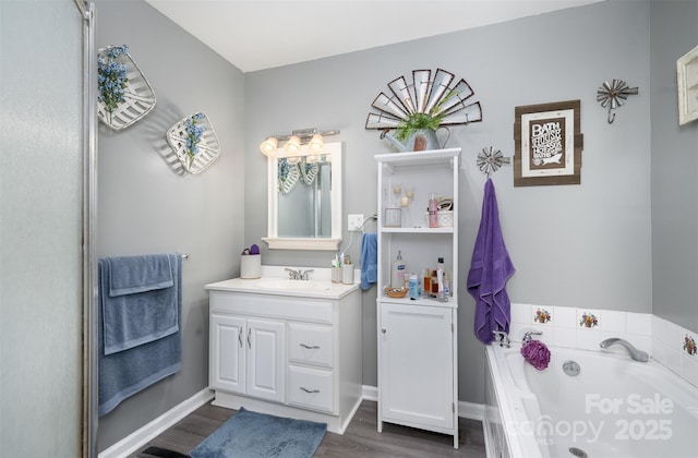 bathroom with wood-type flooring, vanity, and a tub