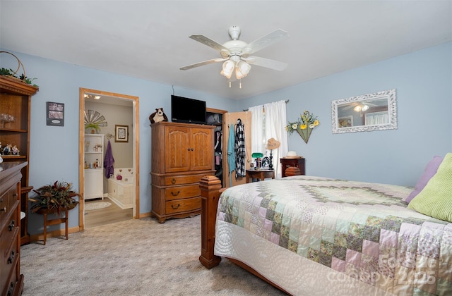 bedroom with ensuite bath, ceiling fan, and light carpet