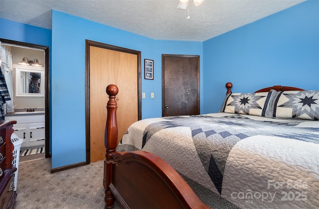 bedroom featuring light carpet, a textured ceiling, and sink