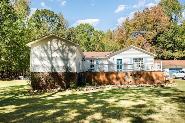 back of house with a lawn and a deck