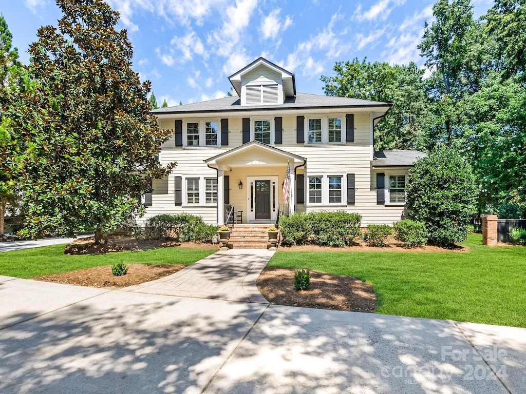 colonial-style house with a front yard