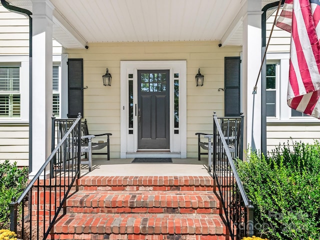 view of exterior entry featuring a porch