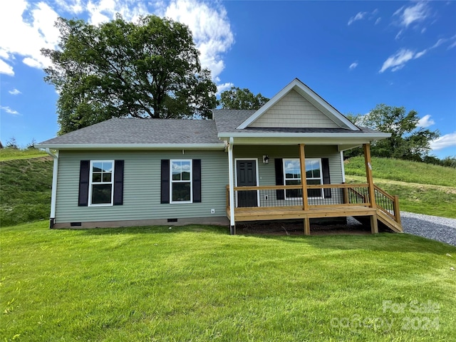 rear view of property with a lawn and a porch