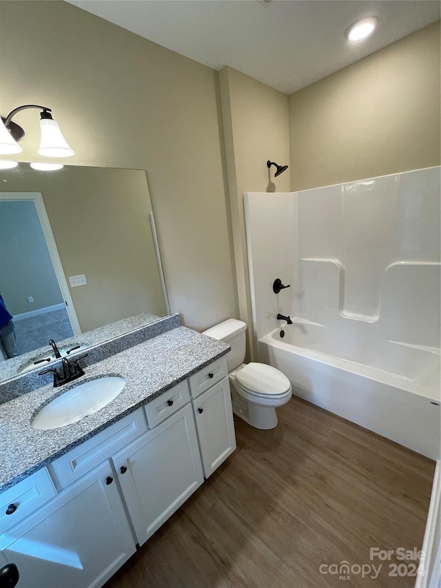 full bathroom featuring shower / tub combination, hardwood / wood-style floors, vanity, and toilet