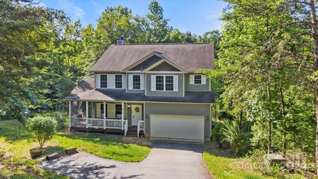 view of front of property featuring covered porch and a garage