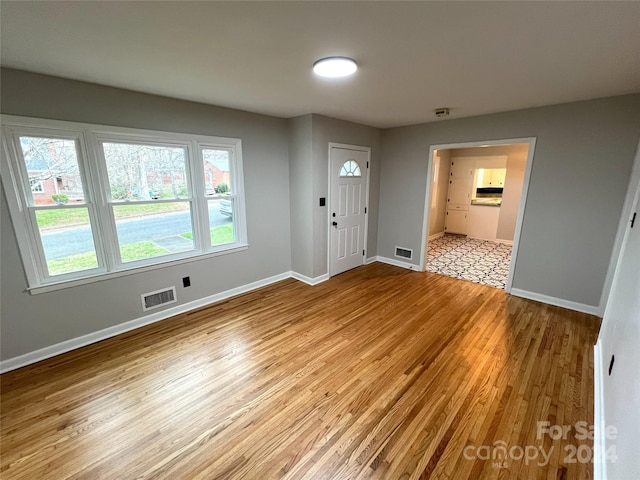 spare room with light hardwood / wood-style flooring