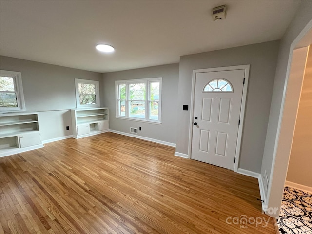 foyer entrance with light hardwood / wood-style floors