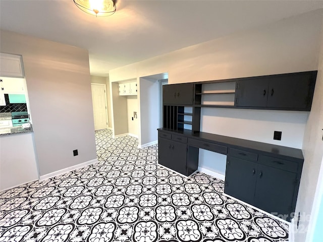 kitchen featuring backsplash and light tile flooring