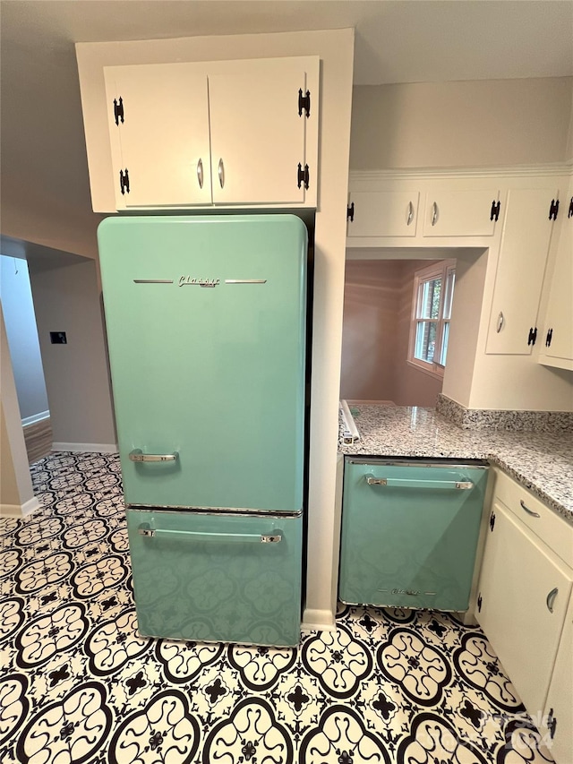 kitchen with fridge, white cabinets, and dishwasher