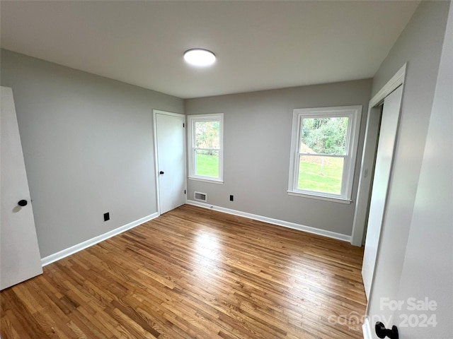 spare room with hardwood / wood-style flooring