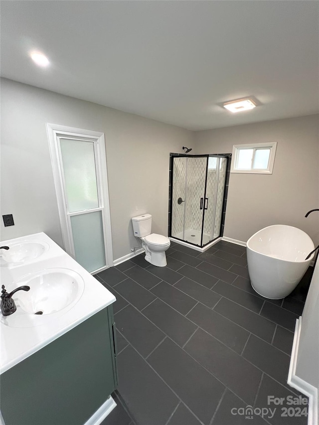 bathroom featuring walk in shower, tile floors, toilet, and double vanity