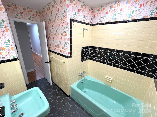 bathroom featuring tile walls, tile floors, and sink