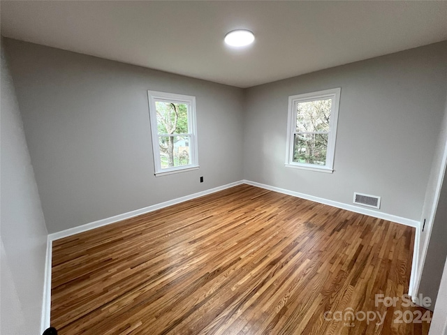 spare room featuring hardwood / wood-style floors