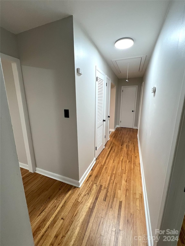 hall with light hardwood / wood-style flooring