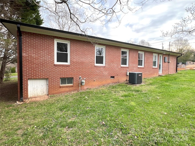 back of house with a yard and central AC unit