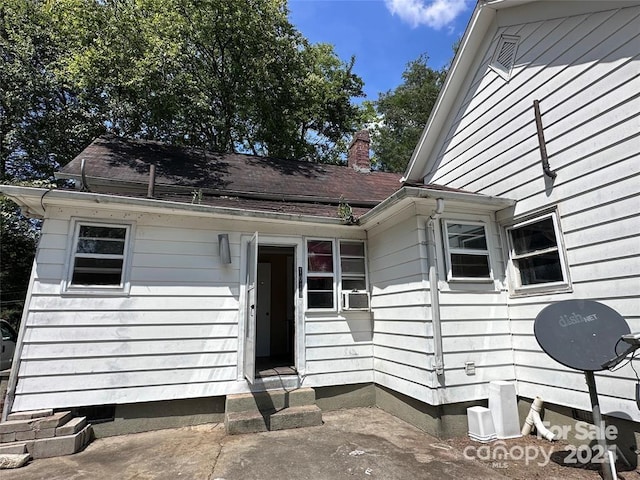 property entrance featuring cooling unit and a patio