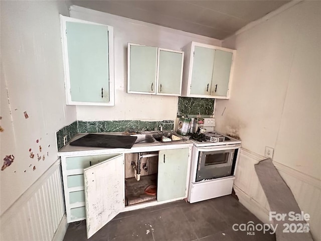 kitchen with white cabinetry, sink, and white gas range oven