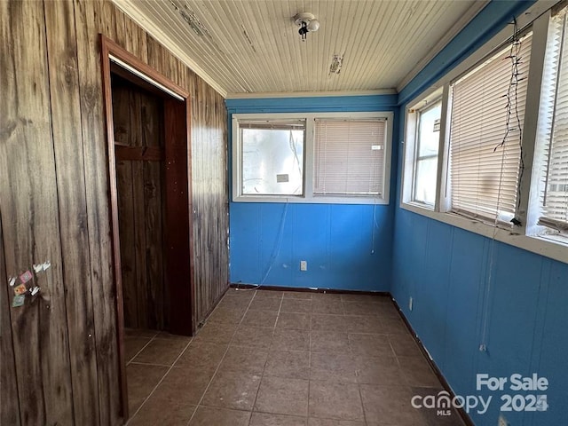 interior space with wood ceiling and wood walls