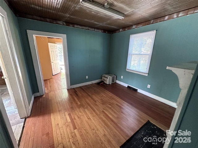 unfurnished room with wood-type flooring