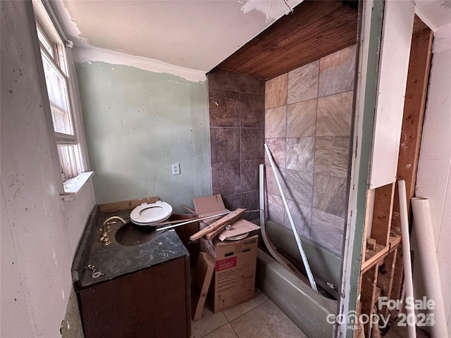 bathroom featuring tile patterned floors, vanity, and a tub