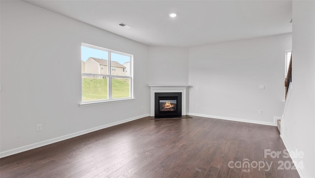 unfurnished living room featuring dark wood-type flooring