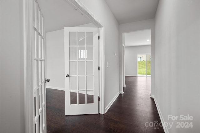 hall with french doors and dark wood-type flooring