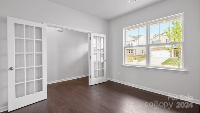 unfurnished room featuring french doors and dark hardwood / wood-style floors