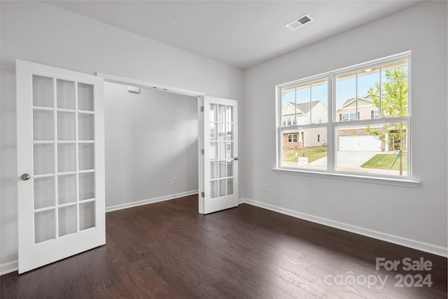 empty room with french doors and dark wood-type flooring