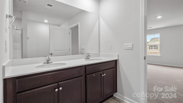 bathroom with dual sinks and oversized vanity