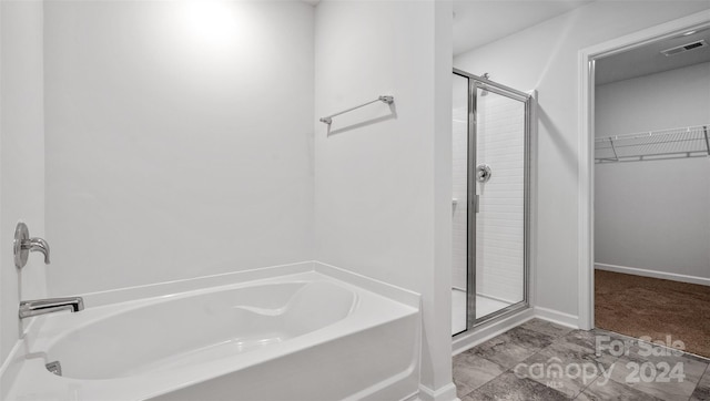 bathroom with separate shower and tub and tile flooring