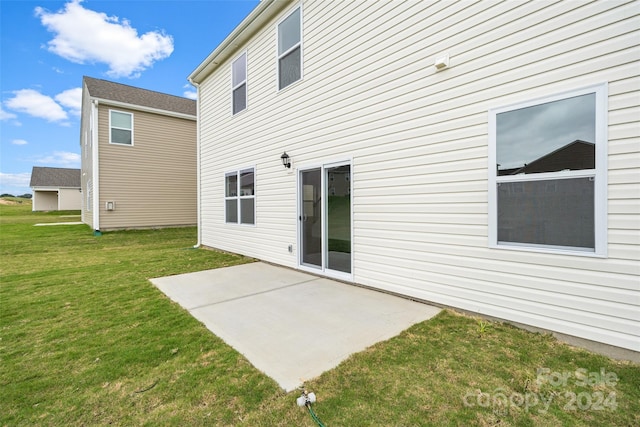 rear view of property featuring a yard and a patio area