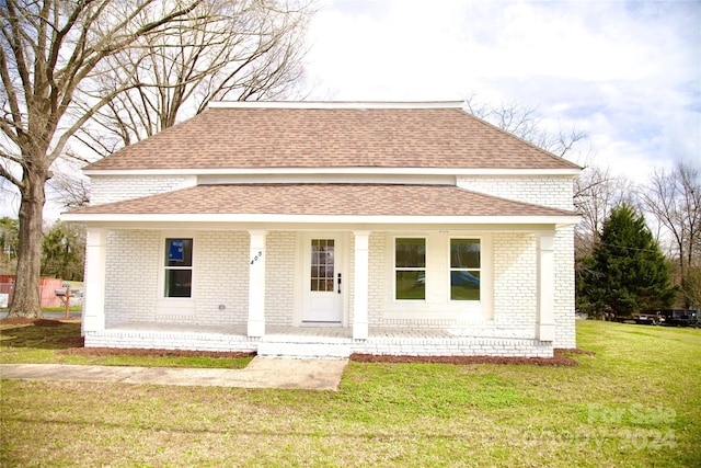 view of front of home with a front yard and a porch