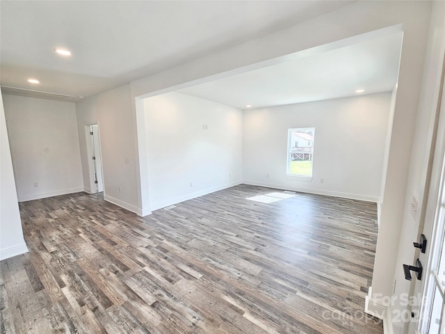 empty room with dark hardwood / wood-style floors