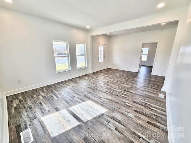 empty room with dark hardwood / wood-style flooring