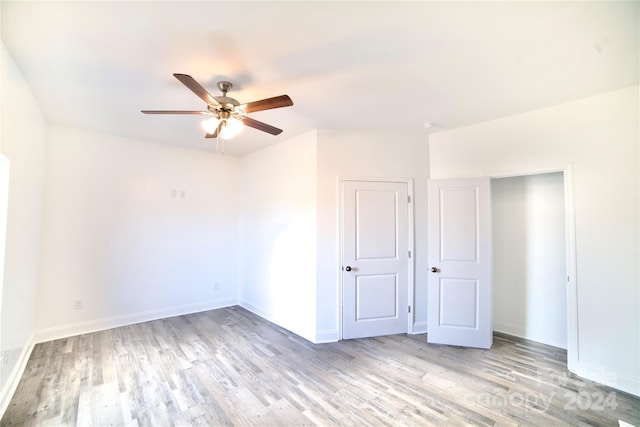 empty room featuring light hardwood / wood-style flooring and ceiling fan