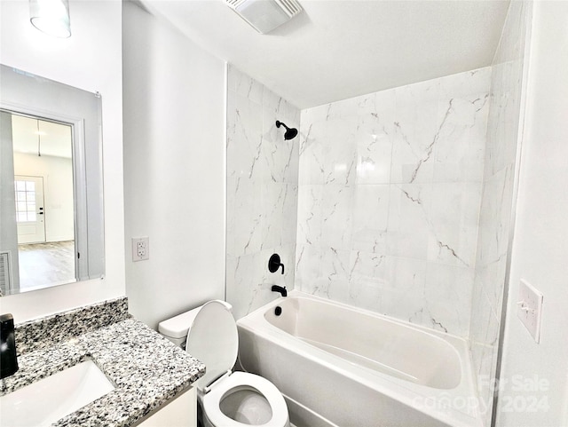 full bathroom featuring tiled shower / bath combo, oversized vanity, and toilet