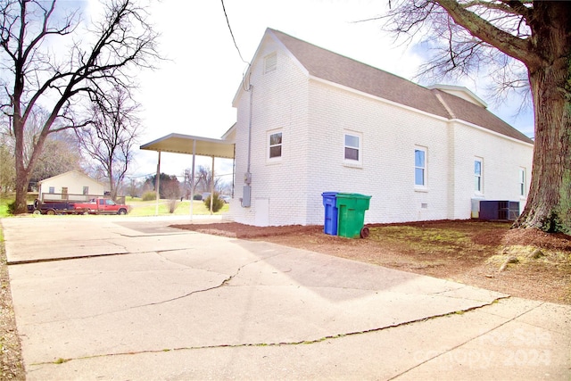 view of side of property with central AC unit