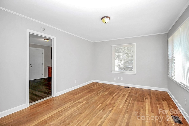 unfurnished room with hardwood / wood-style flooring and crown molding