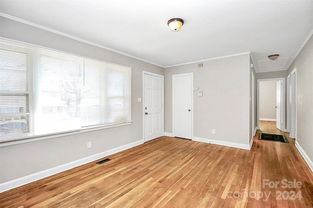 entrance foyer featuring crown molding and hardwood / wood-style floors