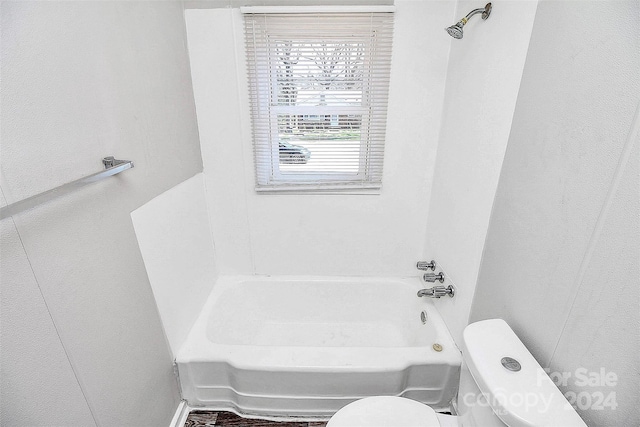 bathroom featuring shower / bathtub combination and toilet