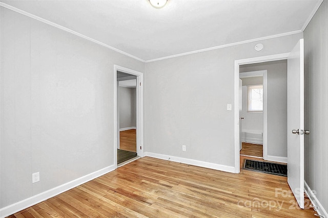 unfurnished bedroom with wood-type flooring and ornamental molding