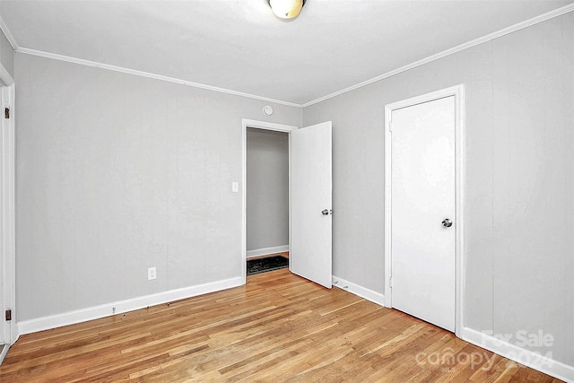 unfurnished bedroom with light hardwood / wood-style floors and ornamental molding