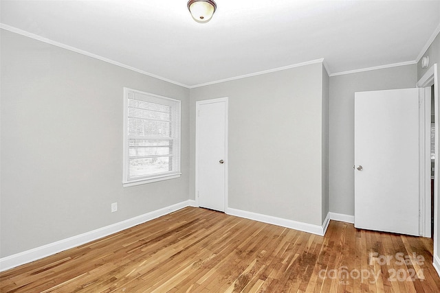 interior space featuring hardwood / wood-style flooring and crown molding