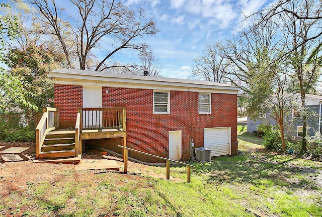 rear view of property with a deck and central AC