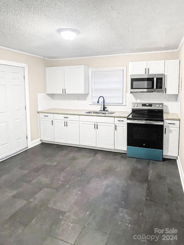 kitchen with stainless steel appliances, white cabinets, a textured ceiling, and sink